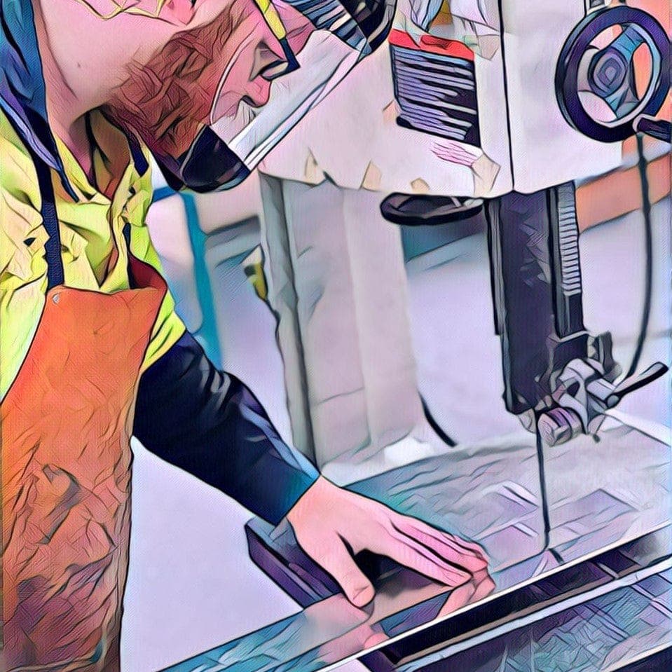 AllBars fabricator cutting aluminium stock on the bandsaw