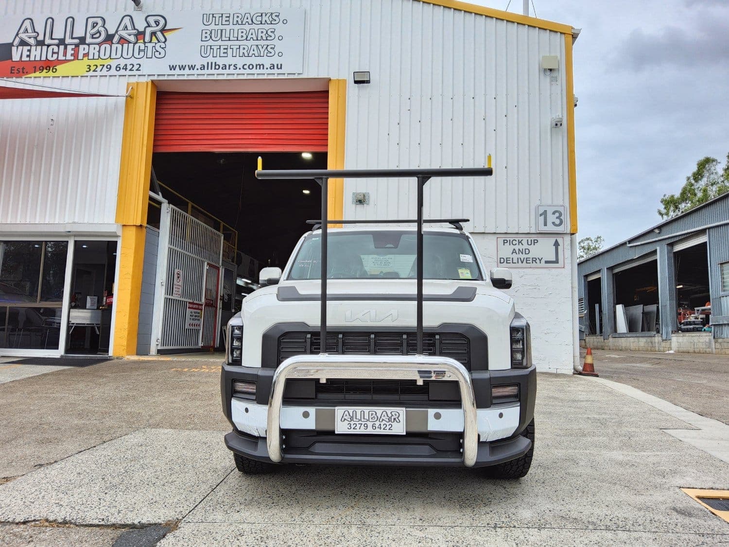 Kia Tasman with AllBars polished nudge bar and H-rack